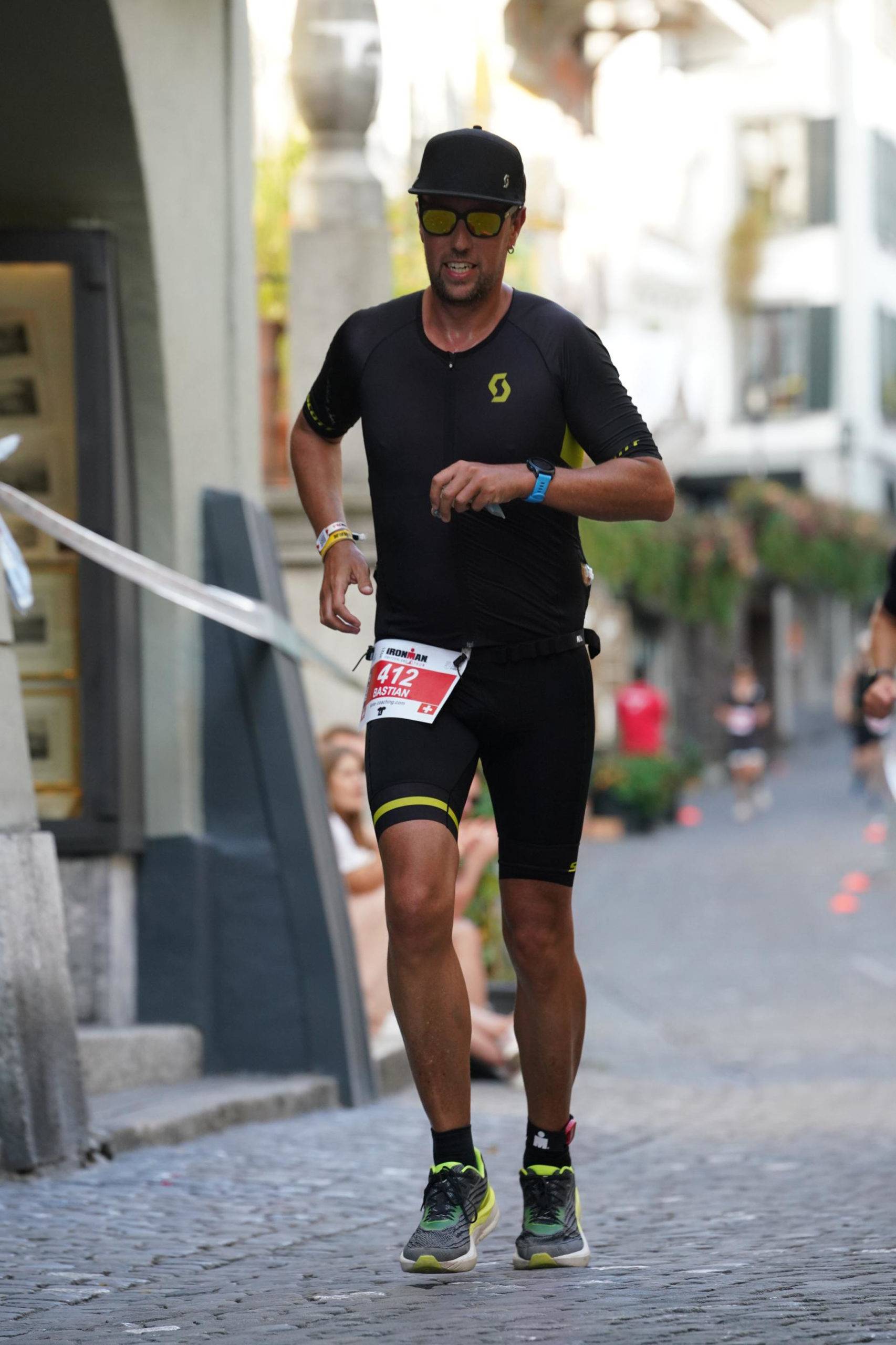 Wearing black and yellow outfit, running through the city